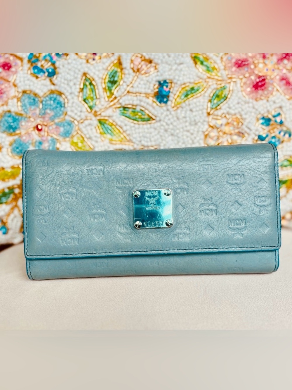 MCM Munchen trifold wallet in new condition except scratches on name plate.